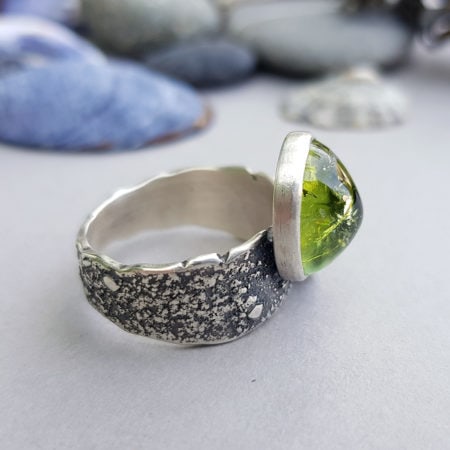Sideways view of green tourmaline ring