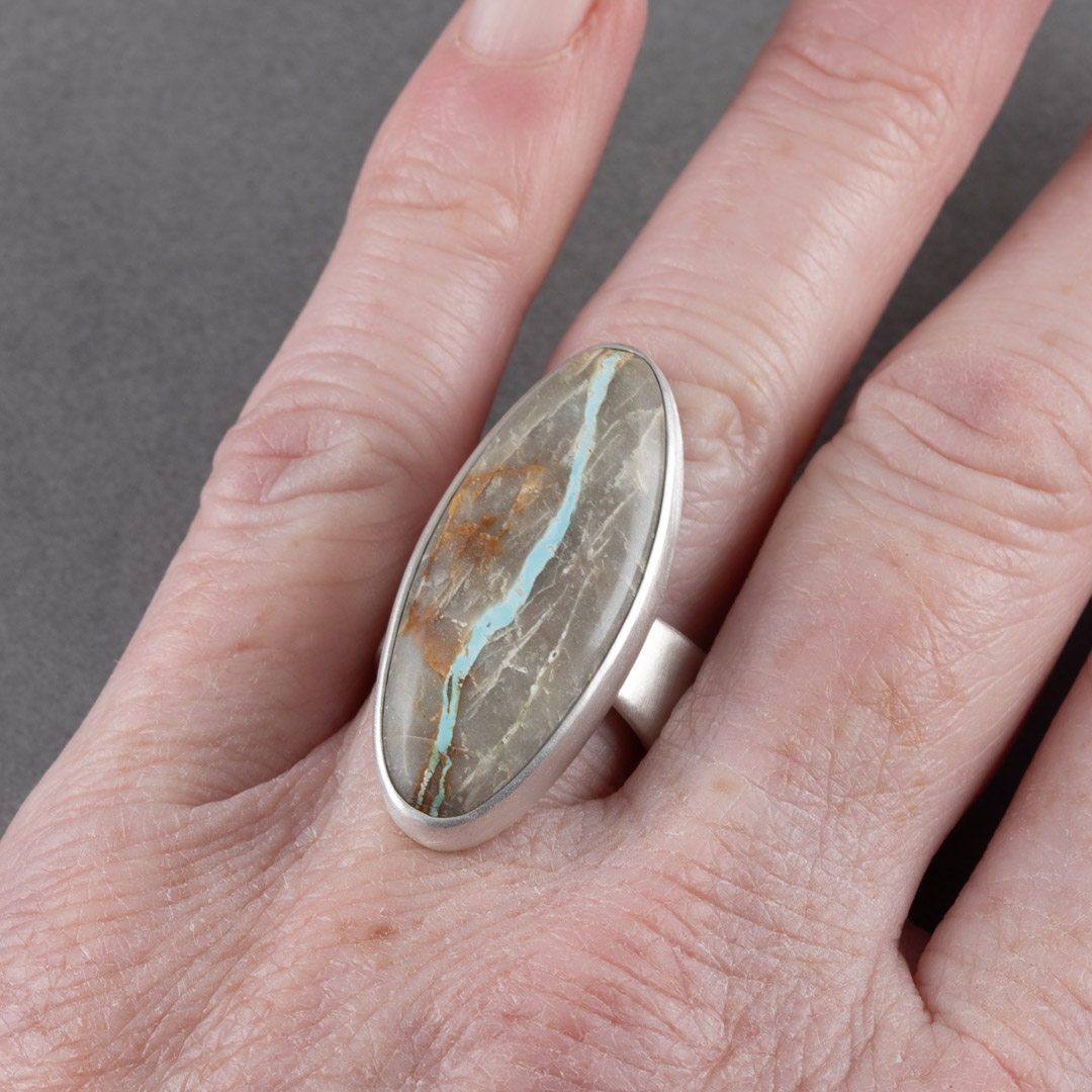 Royston ribbon turquoise ring in brushed sterling silver worn on hand to show scale