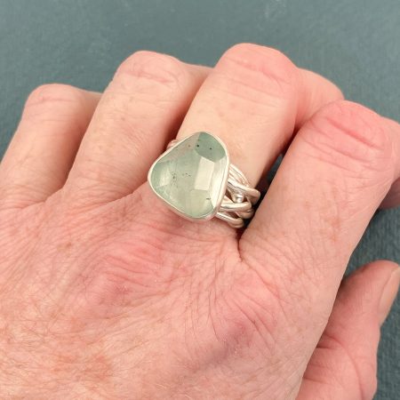 Aquamarine tangled ring in brushed sterling silver worn on hand to show scale
